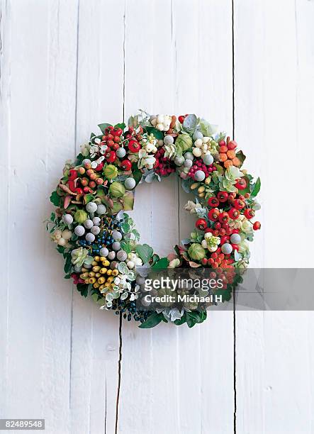 wreath on the white wooden wall - symphoricarpos stock pictures, royalty-free photos & images