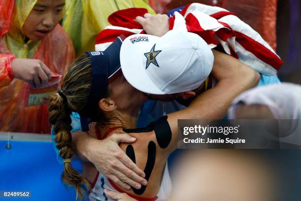 Kerri Walsh of the United States kisses her husband Casey Jennings after she won the gold medal with her partner Misty May-Treanor during the women's...