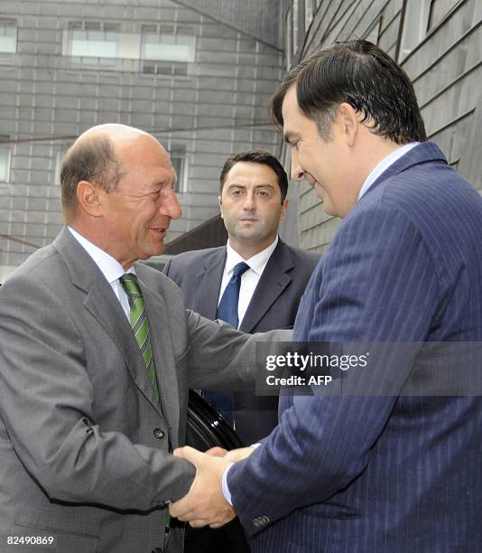 Georgian President Mikheil Saakashvili shakes hands with his Romanian counterpart Traian Basescu in Tbilisi on August 21, 2008. The Russian military...