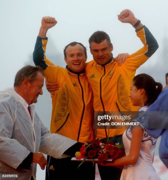 Sailors Darren Bundock and Glenn Ashby of Australia celebrate their silver medal in the tornado class at the 2008 Beijing Olympic Games on August 21,...