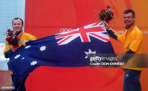 Sailors Darren Bundock and Glenn Ashby of Australia celebrate their silver medal in the tornado class at the 2008 Beijing Olympic Games on August 21,...