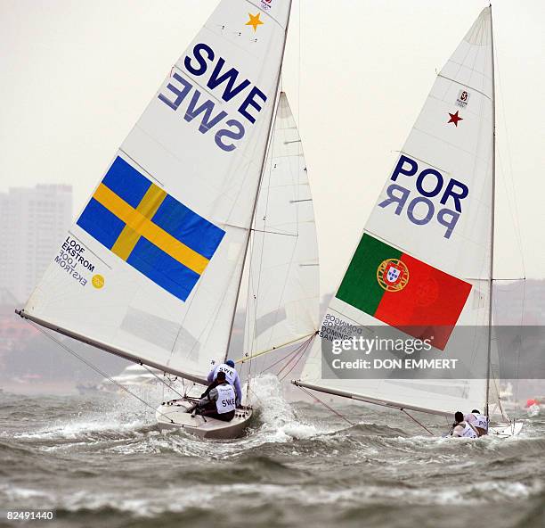 Afonso Domingos and Bernardo Plantier Santos of Portugal sail ahead of Fredrik Loof and Anders Ekstrom of Sweden in the Star class boats medals race...