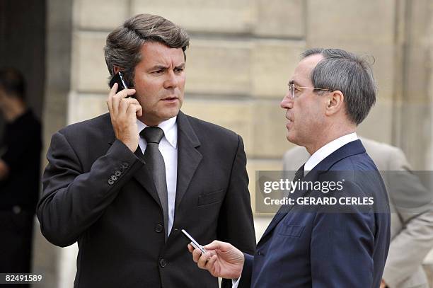 France's president Nicolas Sarkozy's communication adviser Franck Louvrier and Elysee's General Secretary Claude Gueant talk before leaving the...