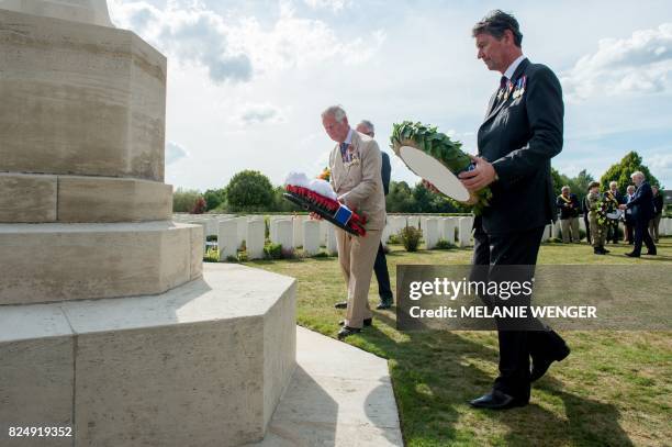 Britain's Prince Charles and Vice Admiral Sir Timothy Laurence lay a wreath during a ceremony at the Artillery Wood Cemetery, in Ypres, on July 31 as...