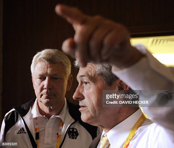 The head of the German show jumping committee, Peter Hofmann , speaks to the media as Reinhard Wendt , chef de mission for the German equestrian...