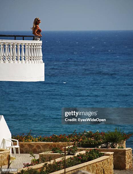 Tourist on a balkony of a reataurant near the village Lindos on August 08, 2008 in Rhodes, Greece. Rhodes is the largest of the greek Dodecanes...