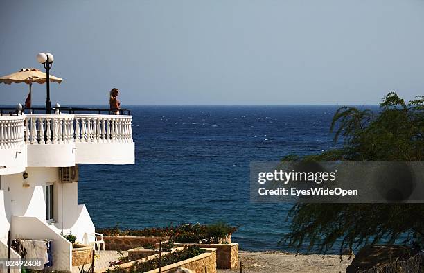 Tourist on a balkony of a reataurant near the village Lindos on August 08, 2008 in Rhodes, Greece. Rhodes is the largest of the greek Dodecanes...