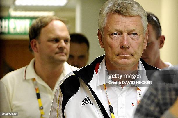 Reinhard Wendt , chef de mission for the German equestrian team, is followed by team veterinarian Bjoern Nolting down a corridor at the equestrian...