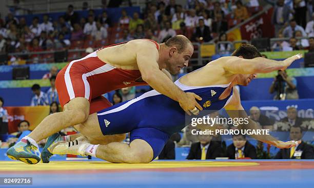 Uzbekistan's Artur Taymazov fights with Bakhtiyar Akhmedov of Russia at the men's freestyle 120kg final wrestling match at the 2008 Beijing Olympic...