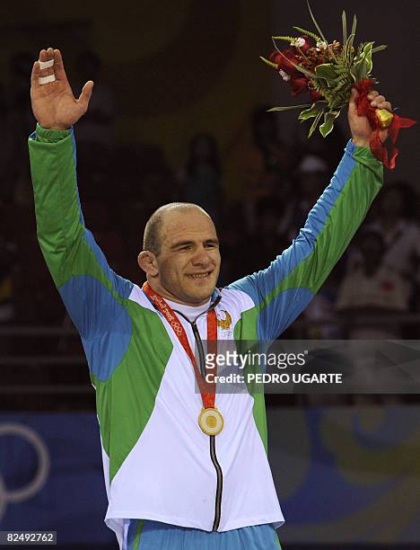 Gold medalist Uzbekistan's Artur Taymazov stands on the podium during the men's freestyle 120kg final wrestling match medal ceremony at the 2008...