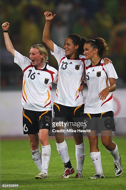 Conny Pohlers, Celia Okoyino Da Mbabi and Fatmire Bajramaj of Germany wave to the fans following their team's victory during the Women's Football...