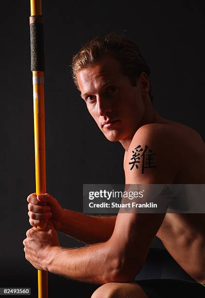 Olympic decathlete Andre Niklaus is seen with his Chinese Zodiac sign Rooster during a photo session on July 3, 2008 in Berlin, Germany.