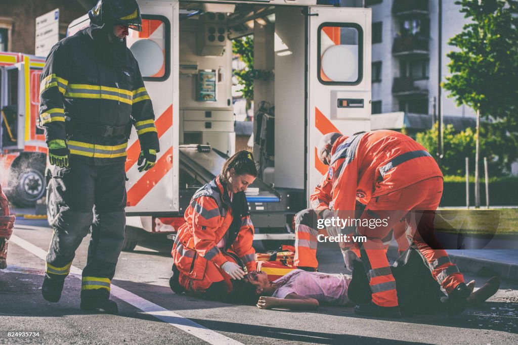 Paramedics with car accident victim