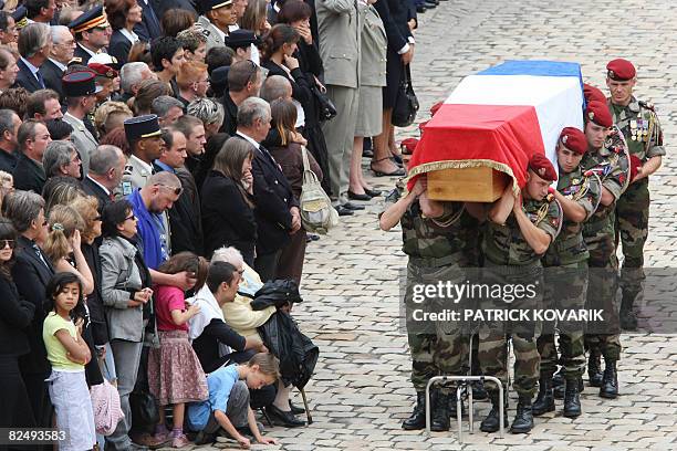 French militaries carry a coffin of one of the 10 soldiers of French NATO troops in Afghanistan, killed earlier this week during fighting following a...