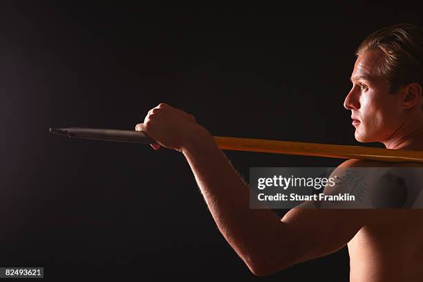 Olympic decathlete Andre Niklaus is seen with his Chinese Zodiac sign Rooster during a photo session on July 3, 2008 in Berlin, Germany.