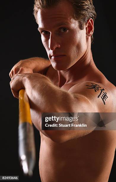 Olympic decathlete Andre Niklaus is seen with his Chinese Zodiac sign Rooster during a photo session on July 3, 2008 in Berlin, Germany.