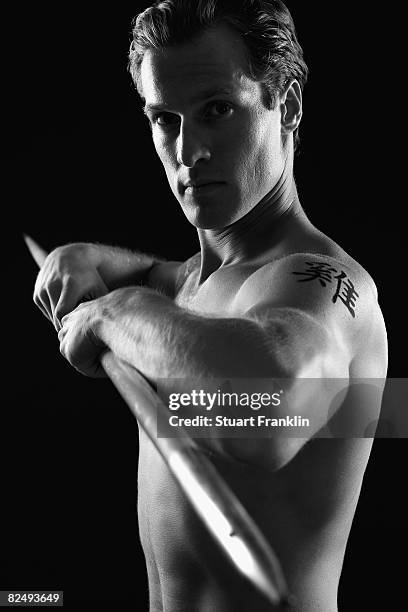 Olympic decathlete Andre Niklaus is seen with his Chinese Zodiac sign Rooster during a photo session on July 3, 2008 in Berlin, Germany.