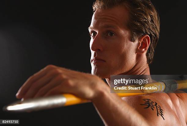 Olympic decathlete Andre Niklaus is seen with his Chinese Zodiac sign Rooster during a photo session on July 3, 2008 in Berlin, Germany.