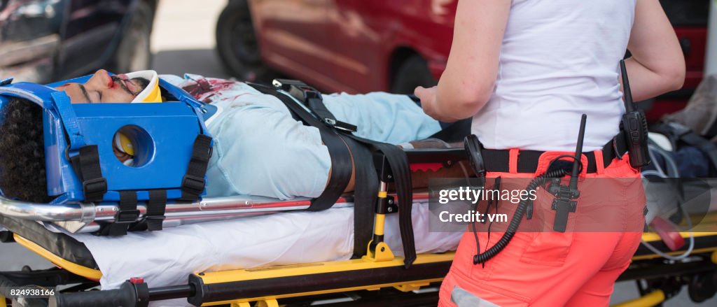 Paramedic helping injured man