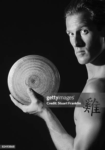 Olympic decathlete Andre Niklaus is seen with his Chinese Zodiac sign Rooster during a photo session on July 3, 2008 in Berlin, Germany.