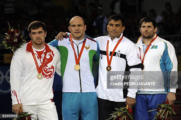 Silver medalist Russia's Bakhtiyar Akhmedov, gold medalist Uzbekistan's Artur Taymazov, and bronze medalists Slovakia's David Musulbes and...