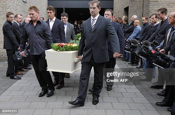 Dutch cameramen have put their cameras on the ground during the funeral of their mlate colleague Stan Storimans, on August 21, 2008 in Tilburg....