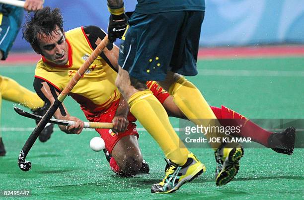 Spain's Eduard Arbos fights for the ball with Australia's David Guest during the semifinal match between Spain and Australia at the Olympic Green...