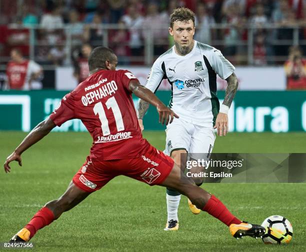 Fernando of FC Spartak Moscow vies for the ball with Pavel Mamayev of FC Krasnodar during the Russian Premier League match between FC Spartak Moscow...