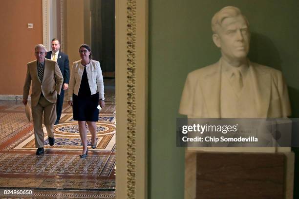 Senate Majority Leader Mitch McConnell and Senate Secretary for the Majority Laura Dove head for the Senate Floor at the U.S. Capitol July 31, 2017...