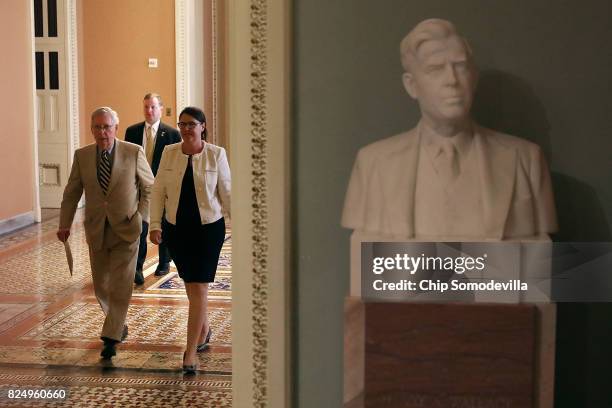 Senate Majority Leader Mitch McConnell and Senate Secretary for the Majority Laura Dove head for the Senate Floor at the U.S. Capitol July 31, 2017...