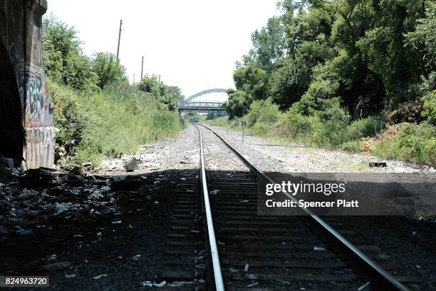 Trash is left behind on train tracks in what was a heroin shooting gallery in the Kensington section of Philadelphia which has become a hub for...