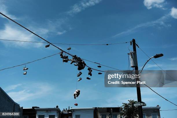 Sneakers hang from phone lines near what was a heroin shooting gallery in the Kensington section of Philadelphia which has become a hub for heroin...