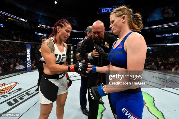 Cris Cyborg of Brazil and Tonya Evinger touch gloves before their UFC women's featherweight championship bout during the UFC 214 event inside the...