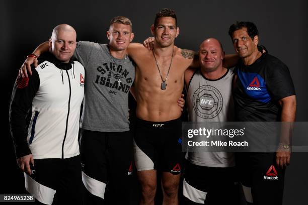 Chris Weidman and his team pose for a post fight portrait backstage during the UFC Fight Night event inside the Nassau Veterans Memorial Coliseum on...