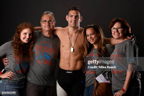 Chris Weidman and his family pose for a post fight portrait backstage during the UFC Fight Night event inside the Nassau Veterans Memorial Coliseum...