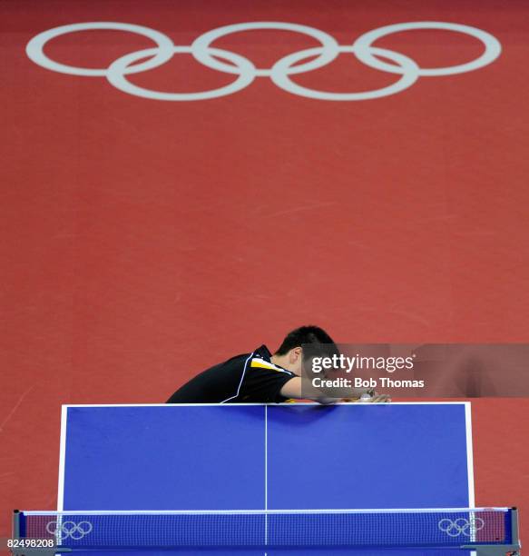 Dimitrij Ovtcharov of Germany serves to Adrian Crisan of Romania during their men's table tennis single preliminary match during Day 12 of the...