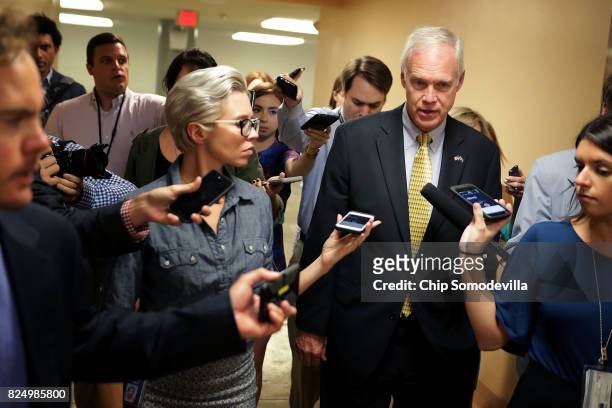 Sen. Ron Johnson talks to reporters as he heads to the U.S. Capitol for a vote July 31, 2017 in Washington, DC. Senate GOP leadership was unable to...