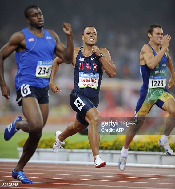 Athlete Bryan Clay competes next to Brazil's Carlos Chinin and Liberia's Jangy Addy during the men's decathlon 400m heat at the National Stadium in...