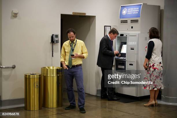 Sen. Mark Warner pauses to use the ATM following a vote at the U.S. Capitol July 31, 2017 in Washington, DC. Senate GOP leadership was unable to...