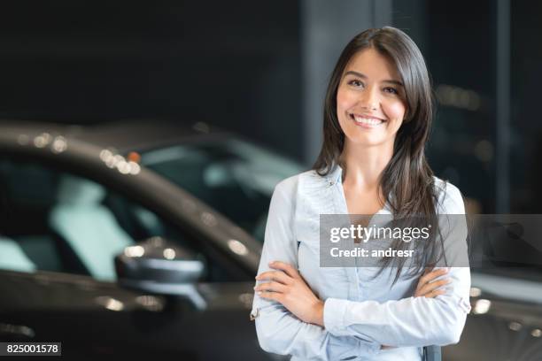 happy woman buying a car at the dealership - saleswoman stock pictures, royalty-free photos & images