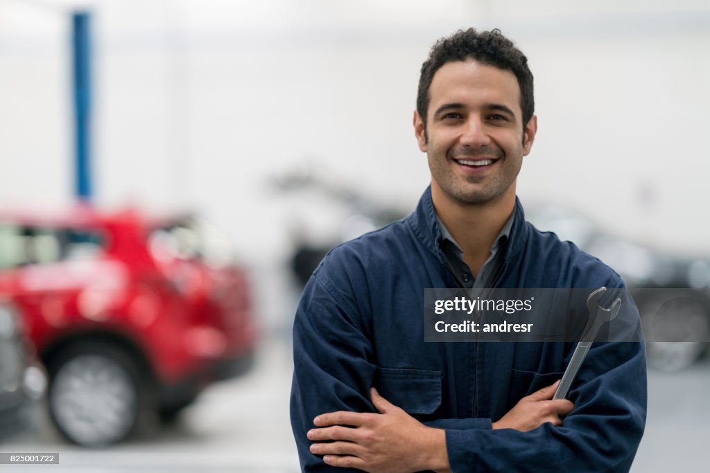 Happy mechanic working at an auto repair shop