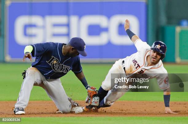 Jose Altuve of the Houston Astros steals second base as Adeiny Hechavarria of the Tampa Bay Rays is late with the tag in the first inning at Minute...