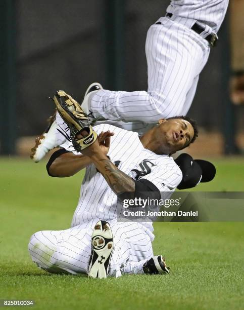 Willy Garcia of the Chicago White Sox is hit in the head by teammate Yoan Moncada as they collide going for a ball hit by Darwin Barney of the...