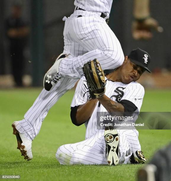 Willy Garcia of the Chicago White Sox is hit in the head by teammate Yoan Moncada as they collide going for a ball hit by Darwin Barney of the...