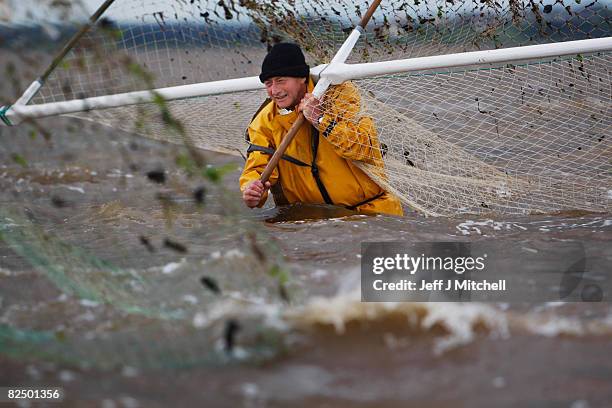 Haaf netters fish on the mudflats of Port Carlisle in the Solway Firth estuary on August 21, 2008 near Wigton in Cumbria, England. The fishing method...