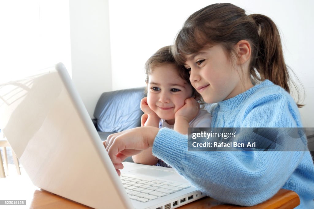 Young girls play with a program on wireless device