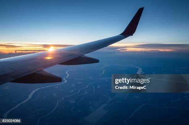 sunset twilight flight - plane crush stock pictures, royalty-free photos & images