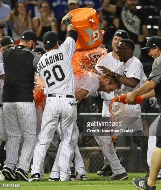 Matt Davidson of the Chicago White Sox is doused with Gatorade by teammate Tyler Saladino after getting the game-winning hit, a run scoring single in...