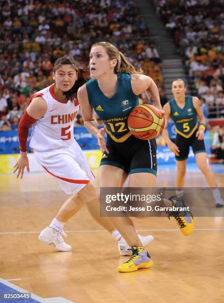 Belinda Snell of Australia drives against Bian Lan of China during the Women's Semifinals basketball game at the Wukesong Indoor Stadium during Day...