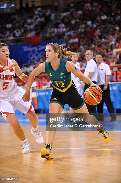 Belinda Snell of Australia drives against Bian Lan of China during the Women's Semifinals basketball game at the Wukesong Indoor Stadium during Day...